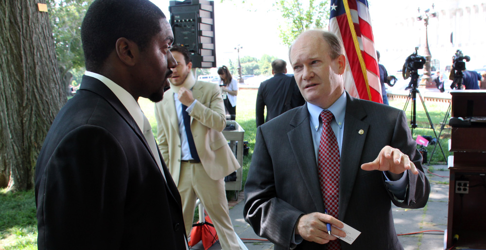 Senator Coons talks with Iraq war veteran Navy Corpsman Eric Smith of Baltimore about his experience trying to find a job after a press conference announcing the Hire America’s Heroes Act outside the Capitol on Wednesday.